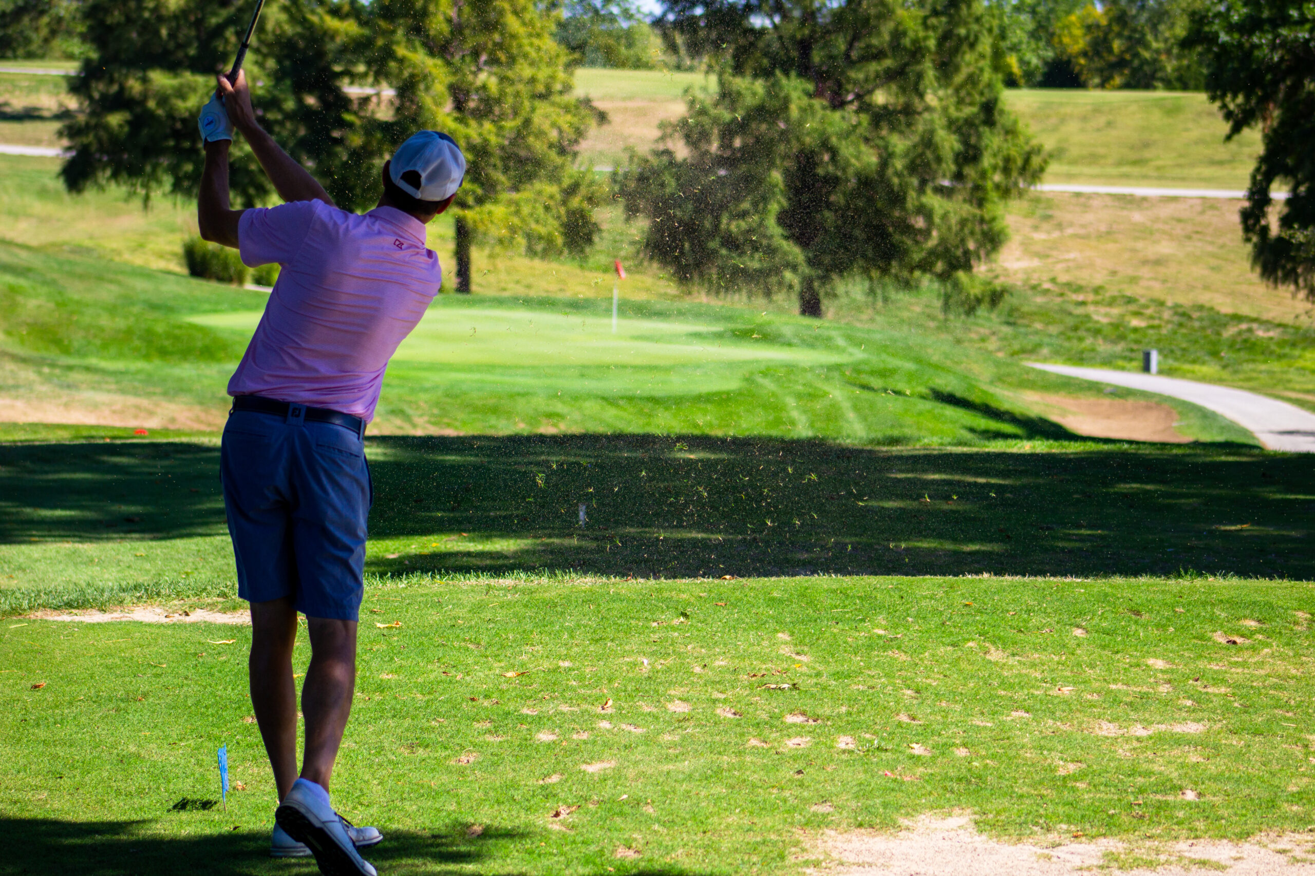 Golfers celebrating on the green during a tournament