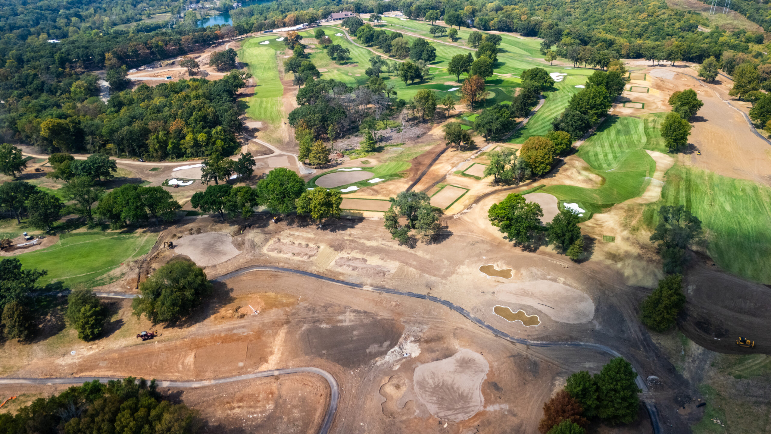 Elevated view of Swope Memorial Golf Course with renovation work in the foreground and the clubhouse in the distance